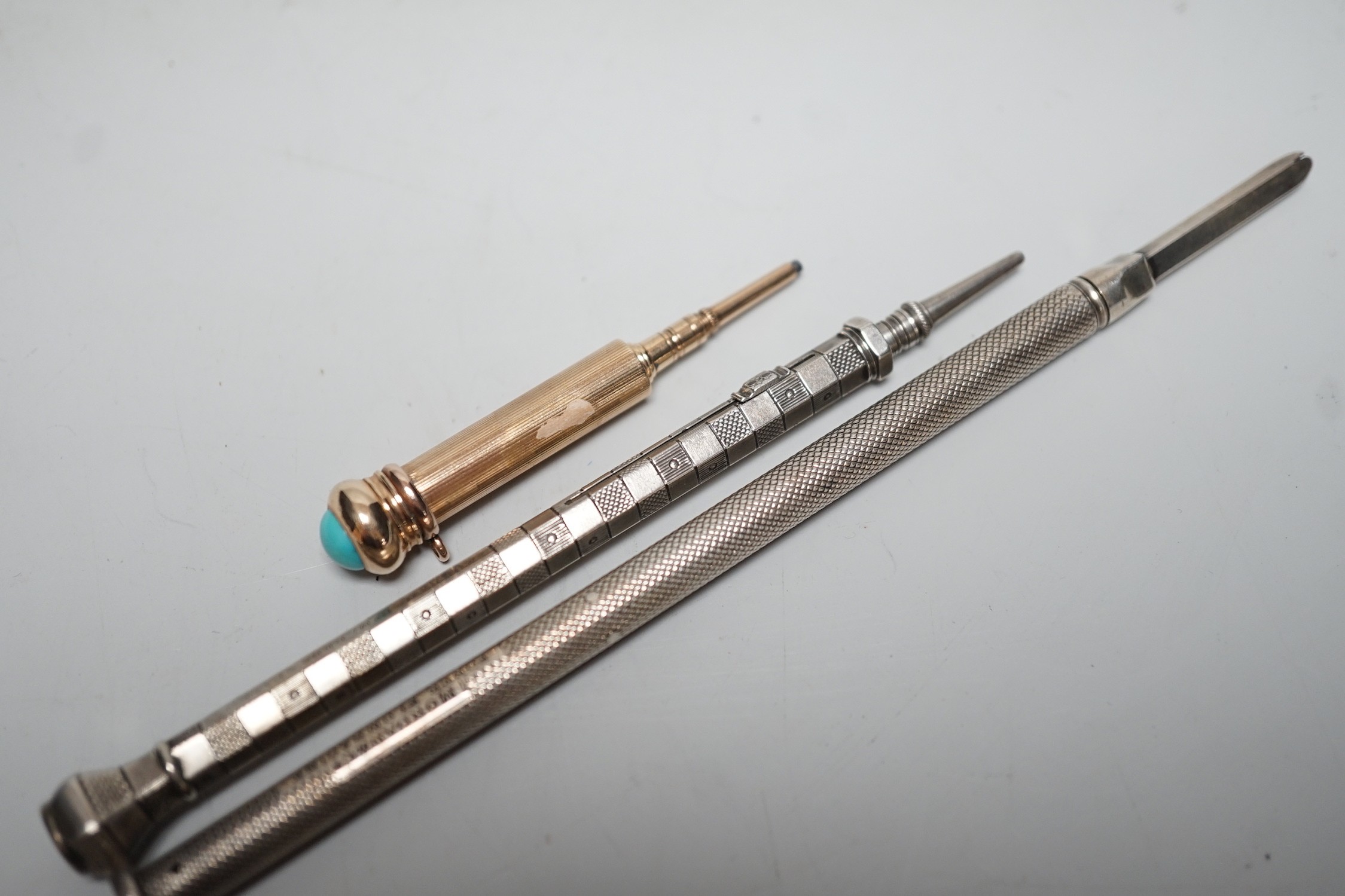 Two silver pencils and a turquoise set propelling pencil